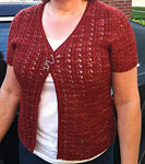 Hand-knit short-sleeved cardigan sweater with Malabrigo Merino Sock Yarn color botticelli red